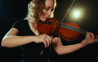 Woman playing the violin with passion