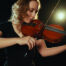 Woman playing the violin with passion
