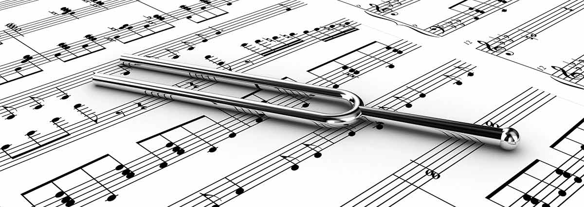 Tuning fork placed on a sheet of music
