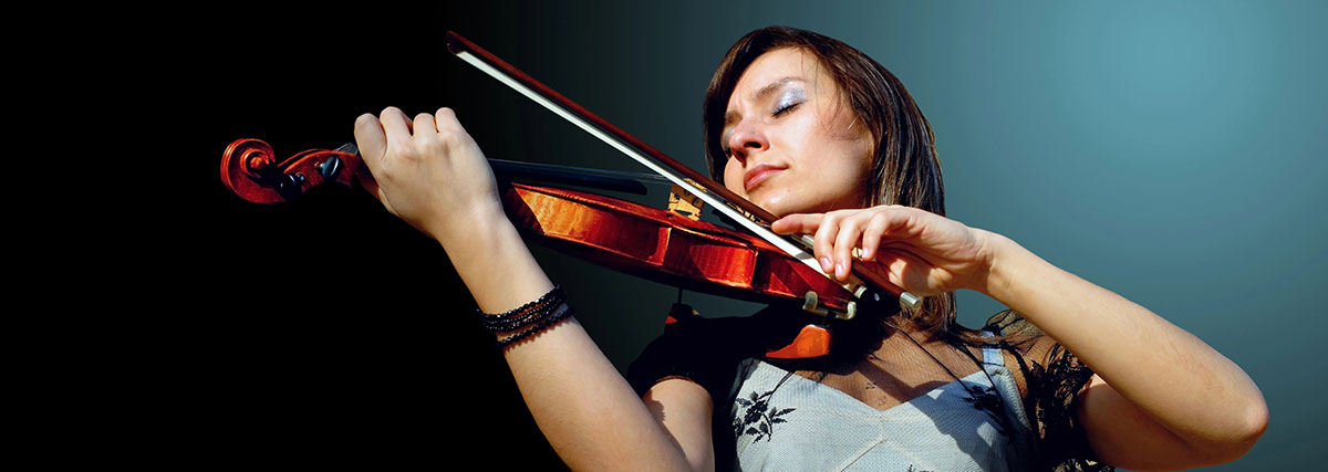 Woman playing the violin with passion