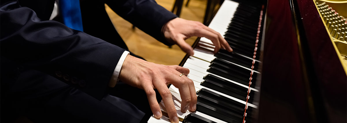 Male hands on the piano keyboard