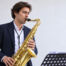 Saxophonist working on intonation and tone control during a practice session